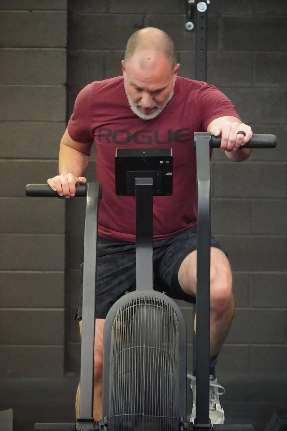 Member pushing hard on an Echo Bike during a CrossFit class at Whit Fitness