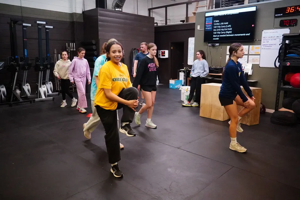 Teen athletes moving through a lunge drill at an ATP youth session